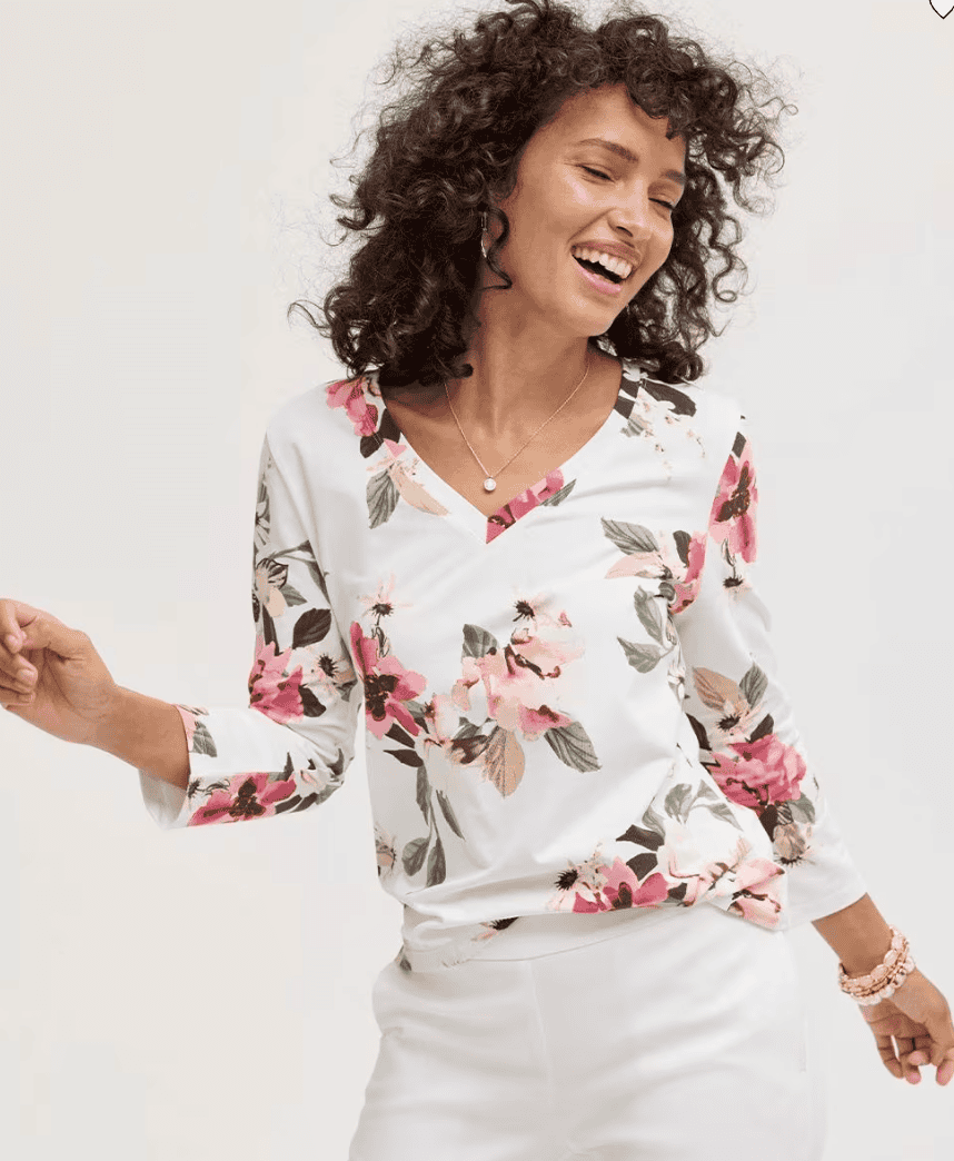 Woman wearing a floral top with 3/4 sleeves