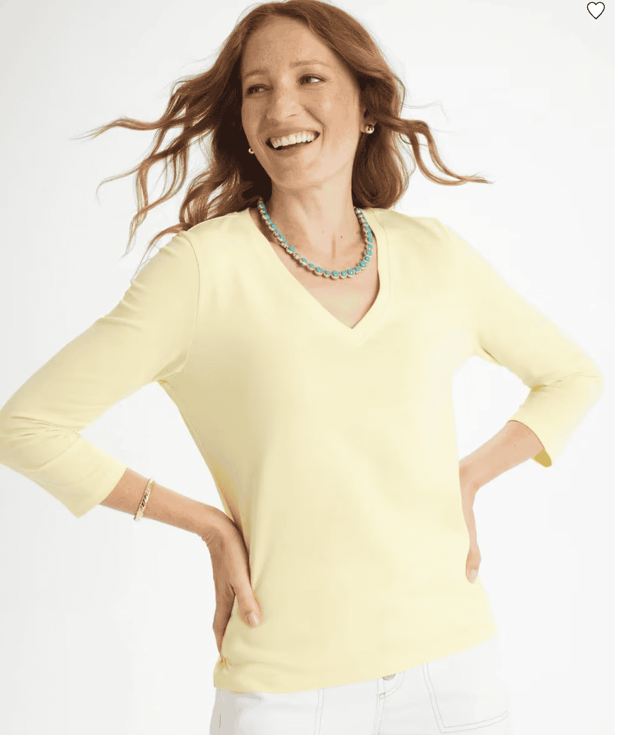 Woman wearing a yellow cotton stretch shirt.