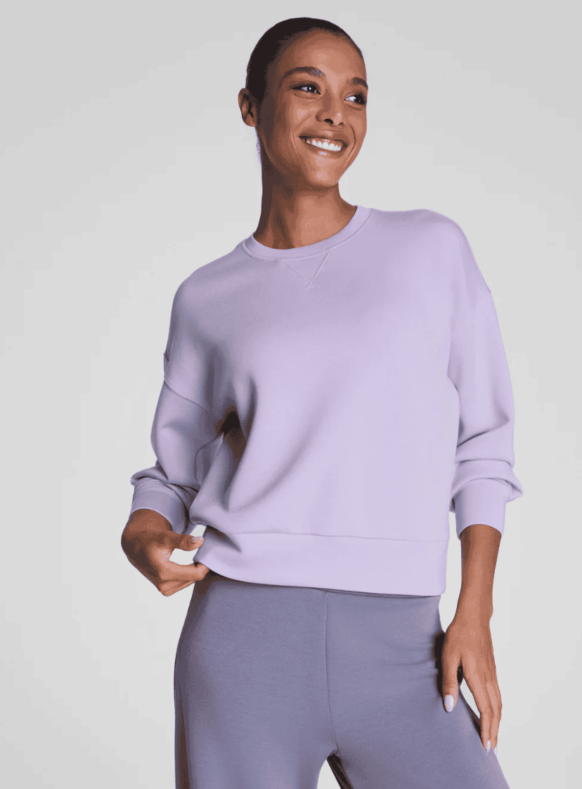 Woman wearing a purple sweatshirt.