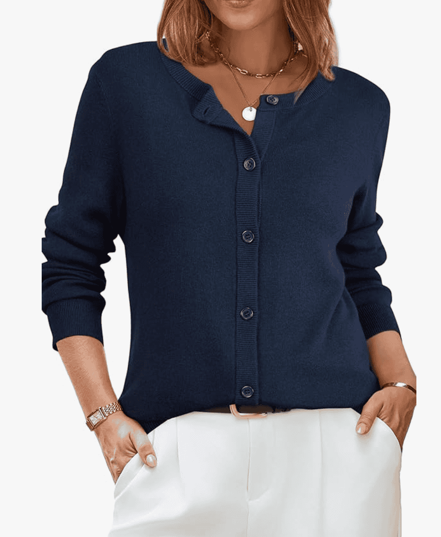 Woman wearing a blue cardigan and white pants.